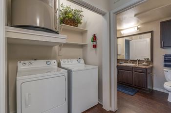A small laundry room with a washer and dryer.